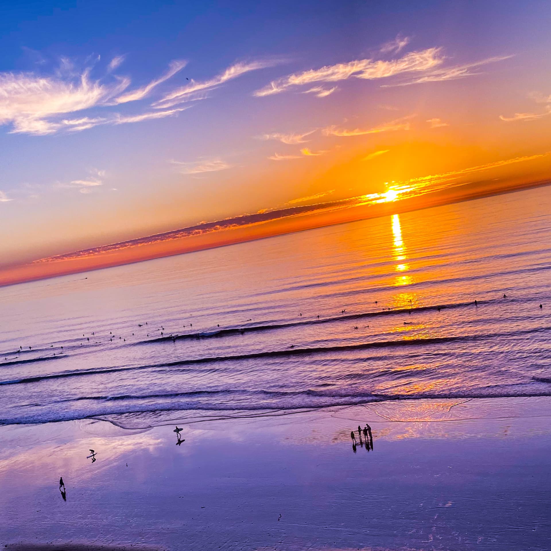 Golden sunset over calm ocean waves at the beach